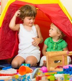 Two tranquil children playing together in home interior